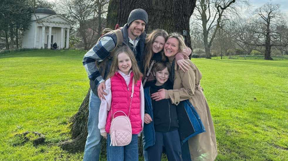 Family posing by tree at Kew Gardens